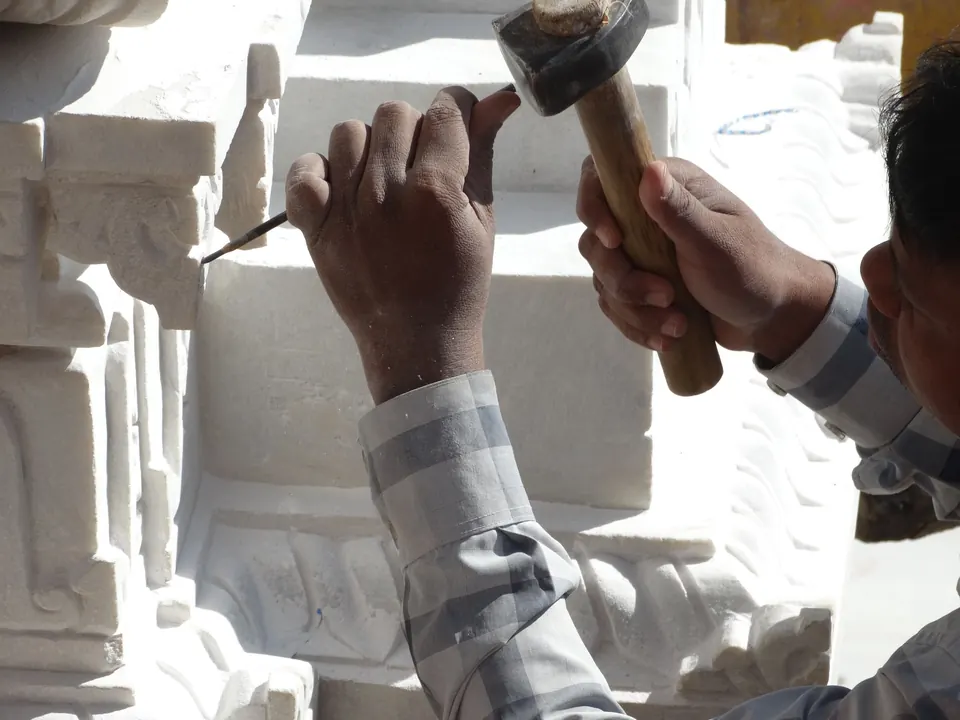Artisan sculptant la pierre au ciseau
